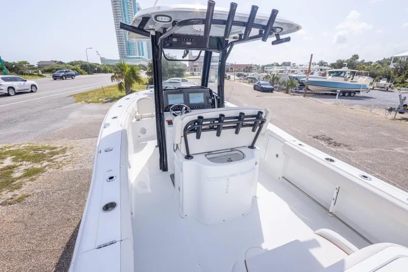 Slide: The Image of 2022 Sea Hunt Gamefish 27 boat with center console, parked near a road. - 14