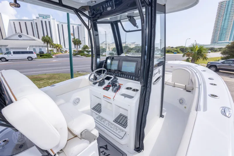 Slide: The Image of 2022 Sea Hunt Gamefish 27 boat interior with modern helm and seating. - 16