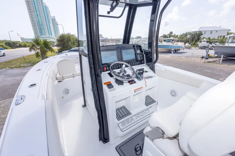 Slide: The Image of 2022 Sea Hunt Gamefish 27 boat cockpit with modern controls and seating. - 17