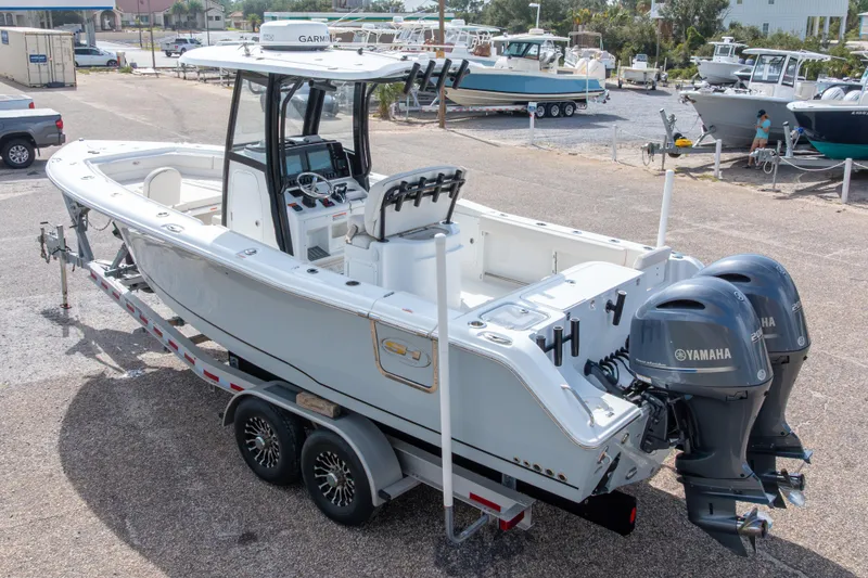 Slide: The Image of 2022 Sea Hunt Gamefish 27 boat with dual Yamaha engines on a trailer. - 8