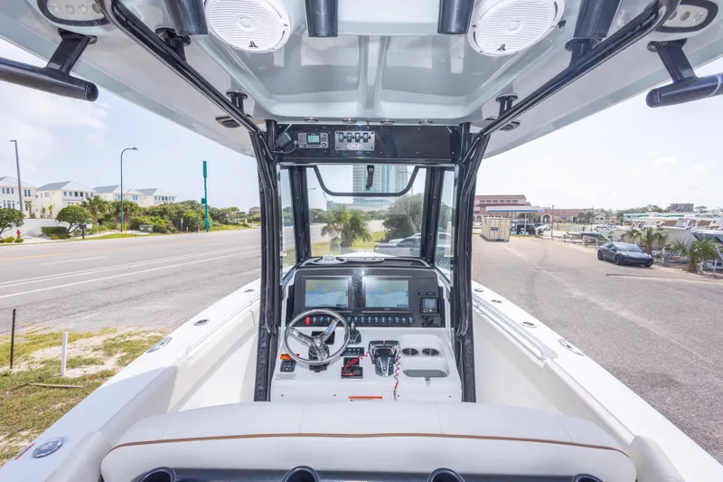 Slide: The Image of 2022 Sea Hunt Gamefish 27 boat interior with advanced navigation system and steering console. - 18