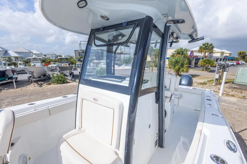 Slide: The Image of 2022 Sea Hunt Gamefish 27 boat with center console and seating, docked outdoors. - 32
