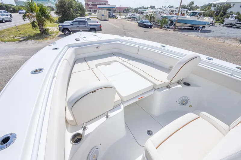 Slide: The Image of 2022 Sea Hunt Gamefish 27 boat interior with white seating and spacious deck. - 25