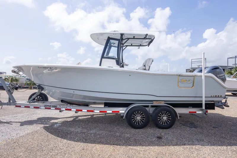Slide: The Image of 2022 Sea Hunt Gamefish 27 boat on trailer under clear sky. - 56