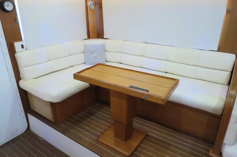 Slide: The Image of Luxurious 2007 Grand Harbour N47 yacht interior with cushioned seating and wooden table. - 37
