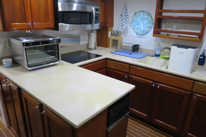 Slide: The Image of Modern kitchen in 2007 Grand Harbour N47 yacht with appliances and wooden cabinetry. - 33