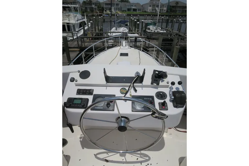 Slide: The Image of 2007 Grand Harbour N47 yacht helm with steering wheel and control panel at marina. - 15