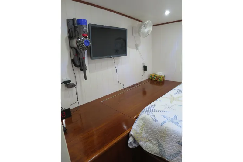Slide: The Image of Interior of 2007 Grand Harbour N47 yacht with TV, fan, and vacuum on wall. - 25