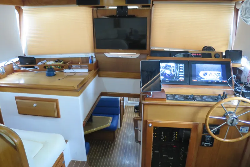 Slide: The Image of Interior of 2007 Grand Harbour N47 yacht with navigation equipment and wooden finishes. - 40