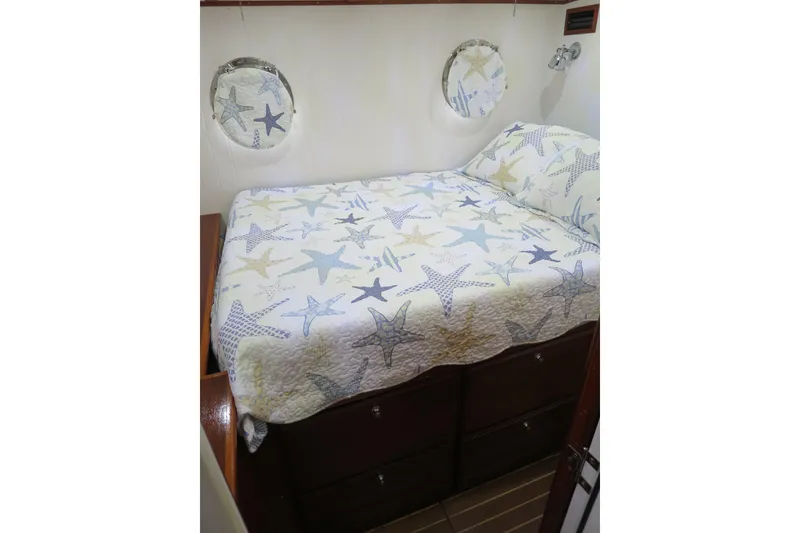 Slide: The Image of Cozy bedroom in 2007 Grand Harbour N47 yacht with starfish-themed bedding. - 24