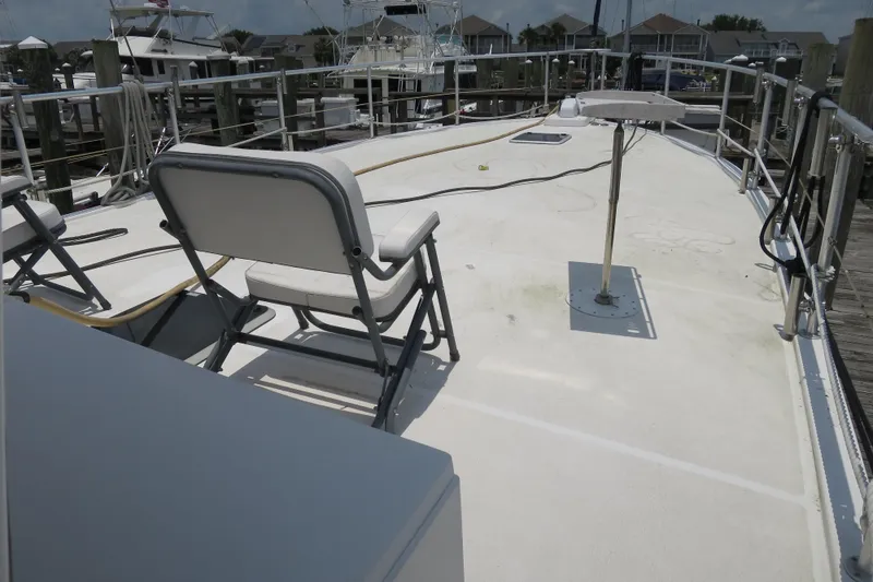 Slide: The Image of Deck of 2007 Grand Harbour N47 yacht with chairs and marina view. - 11