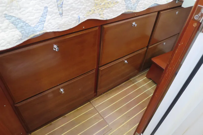 Slide: The Image of Wooden drawers in a 2007 Grand Harbour N47 boat interior. - 26