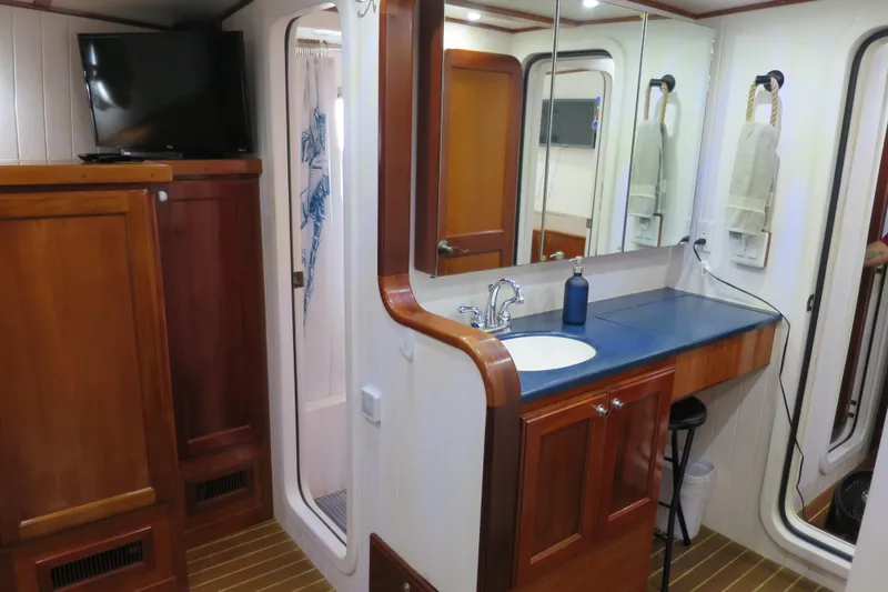 Slide: The Image of Luxurious 2007 Grand Harbour N47 yacht bathroom with wooden cabinetry and modern amenities. - 21
