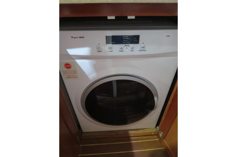 Slide: The Image of Compact dryer installed in a 2007 Grand Harbour N47 yacht, featuring digital controls. - 28