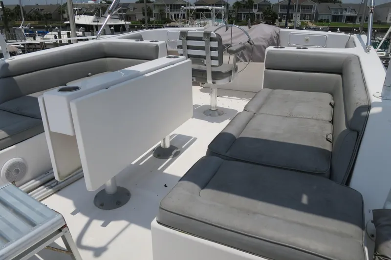 Slide: The Image of Luxurious seating area on a 2007 Grand Harbour N47 yacht, featuring gray cushions and a foldable table. - 14