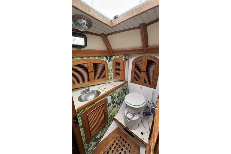 Slide: The Image of Vintage 1980 Passport 40 yacht bathroom with wooden accents and compact design. - 30