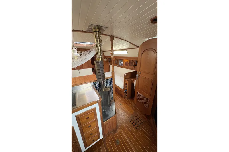 Slide: The Image of Interior of a 1980 Passport 40 sailboat with wooden cabinetry and stove. - 32