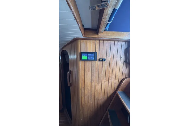Slide: The Image of Wood-paneled interior of 1980 Passport 40 sailboat with mounted control panel. - 33