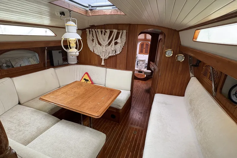 Slide: The Image of Cozy 1980 Passport 40 yacht interior with wooden decor and comfortable seating. - 25
