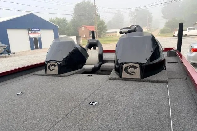 Slide: The Image of 2022 Crestliner MX 21 boat with dual engines, parked outdoors on a foggy day. - 12
