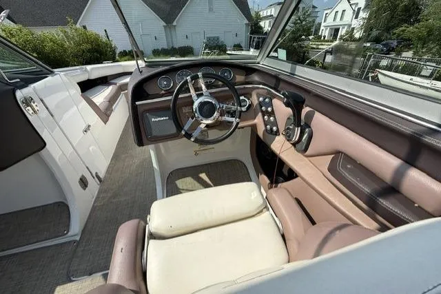 Slide: The Image of Interior view of a 2012 Cobalt 276 boat cockpit with steering wheel and controls. - 21