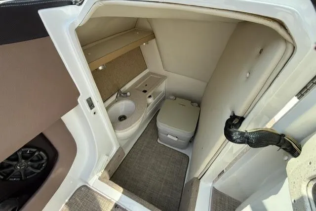 Slide: The Image of Interior of a 2012 Cobalt 276 boat bathroom with toilet and sink. - 34