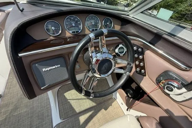 Slide: The Image of Steering wheel and dashboard of a 2012 Cobalt 276 boat with Raymarine equipment. - 36