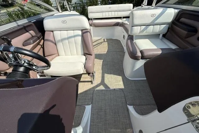 Slide: The Image of Interior of a 2012 Cobalt 276 boat with plush seating and steering wheel. - 16