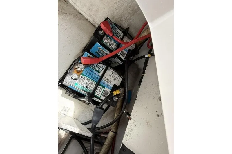 Slide: The Image of Battery compartment of a 2012 Cobalt 276 boat with visible wiring. - 9