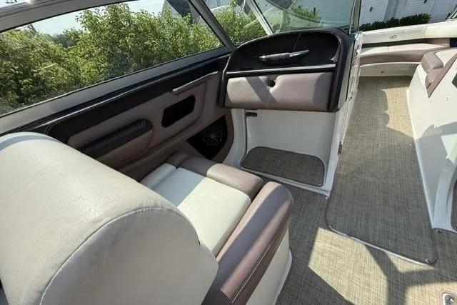 Slide: The Image of Interior of a 2012 Cobalt 276 boat with beige and brown seating. - 12