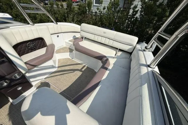 Slide: The Image of Interior of a 2012 Cobalt 276 boat with white and beige seating. - 37