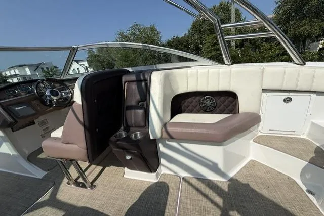 Slide: The Image of Interior of a 2012 Cobalt 276 boat featuring plush seating and modern dashboard. - 13