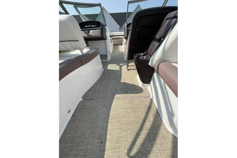 Slide: The Image of Interior view of a 2012 Cobalt 276 boat with beige and brown seating. - 18