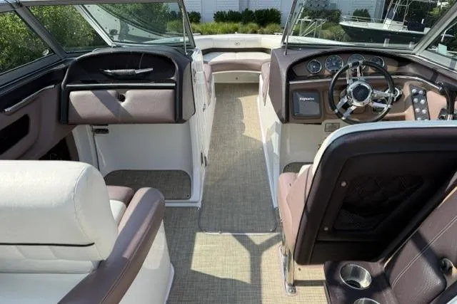Slide: The Image of Interior of a 2012 Cobalt 276 boat with steering wheel and seating. - 25