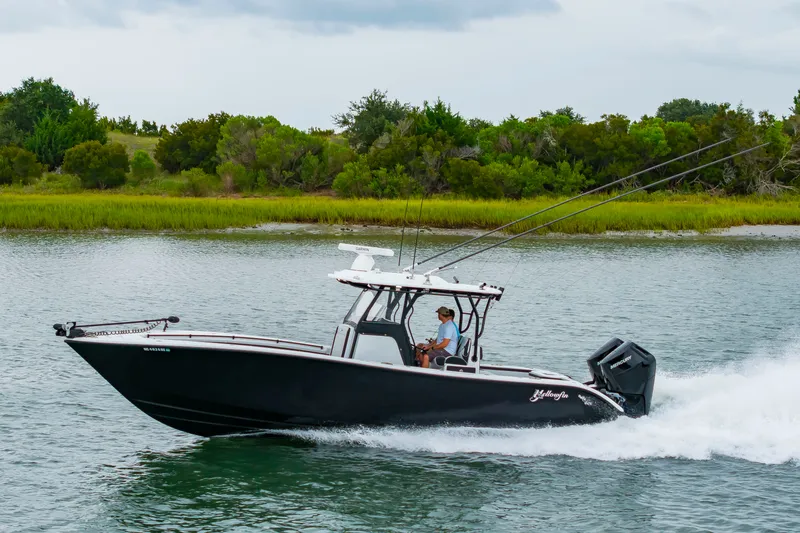 Slide: The Image of 2025 Yellowfin 32 Offshore on the water, featuring dual outboard engines and fishing rods on deck. - 43
