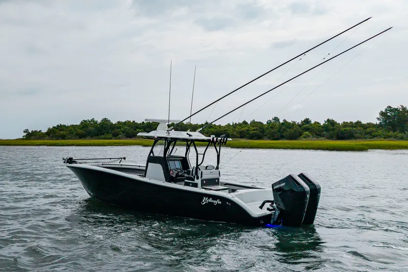 Slide: The Image of A 2025 Yellowfin 32 Offshore boat on the water with dual outboard engines and fishing rods. - 41
