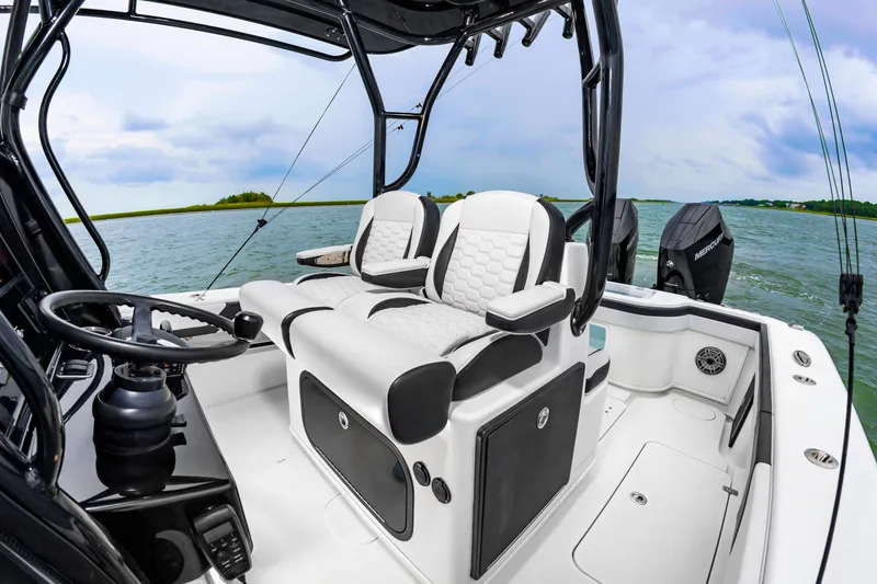 Slide: The Image of The image shows the cockpit of a 2025 Yellowfin 32 Offshore boat with modern seating. - 13