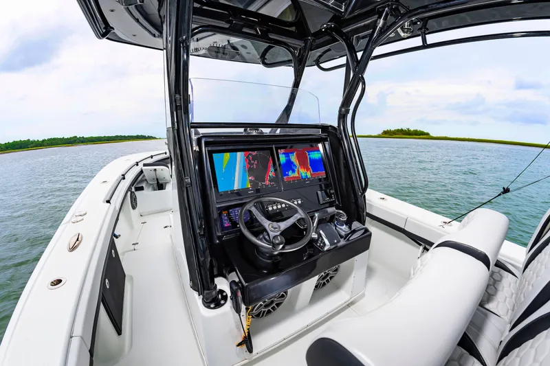 Slide: The Image of The image shows the cockpit of a 2025 Yellowfin 32 Offshore boat with modern navigation systems. - 9