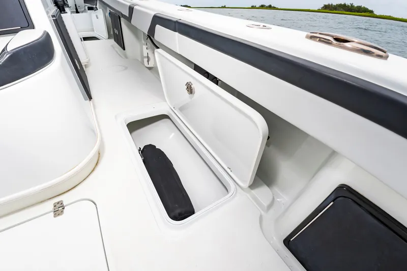 Slide: The Image of The image shows the deck of a 2025 Yellowfin 32 Offshore with an open storage compartment. - 23