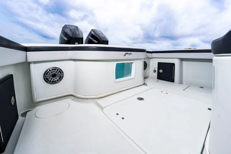 Slide: The Image of The image shows the spacious aft deck of a 2025 Yellowfin 32 Offshore boat with twin outboard engines. - 21