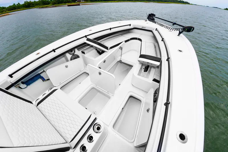 Slide: The Image of The image shows the deck of a 2025 Yellowfin 32 Offshore boat with multiple storage compartments. - 36