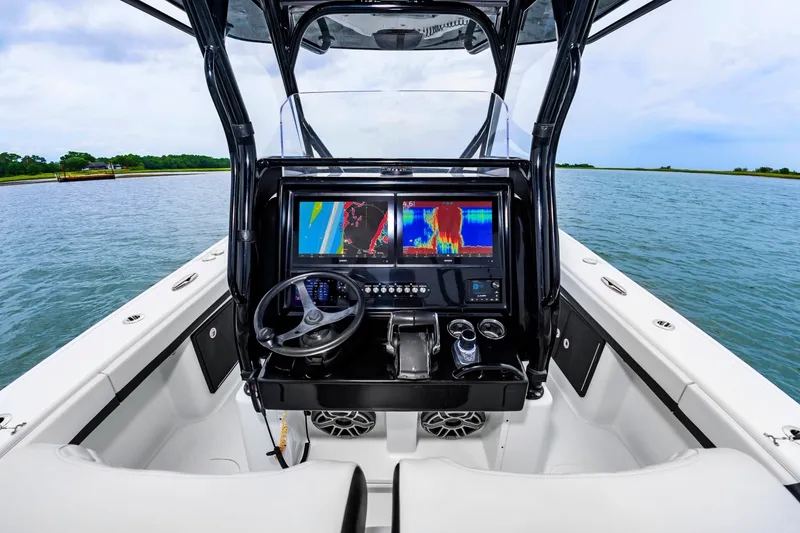 Slide: The Image of The cockpit of the 2025 Yellowfin 32 Offshore features modern navigation screens and a sleek steering wheel. - 10