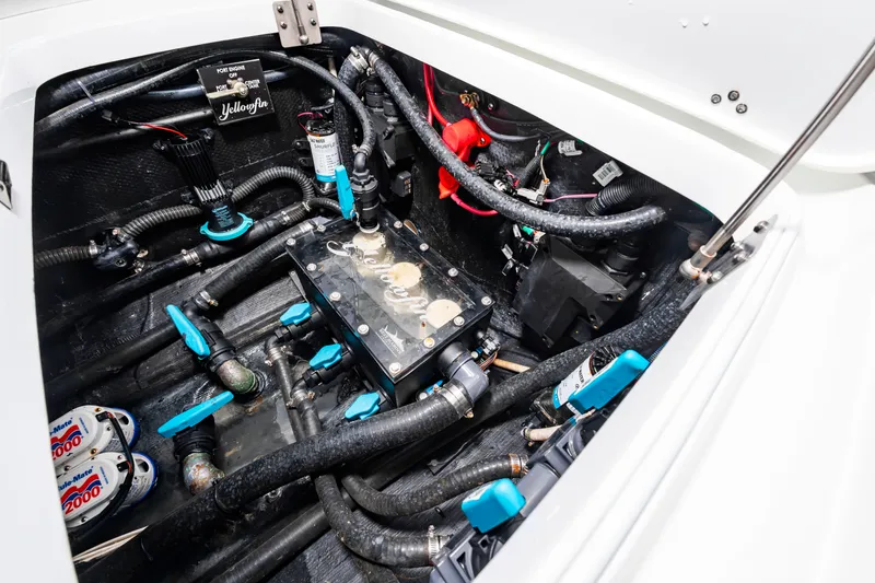 Slide: The Image of A clean engine compartment with hoses, valves, and a filter in a Yellowfin 32 Offshore boat. - 37