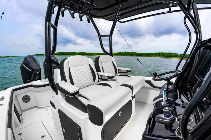Slide: The Image of The image shows the cockpit of a 2025 Yellowfin 32 Offshore with luxurious seating and modern equipment. - 12