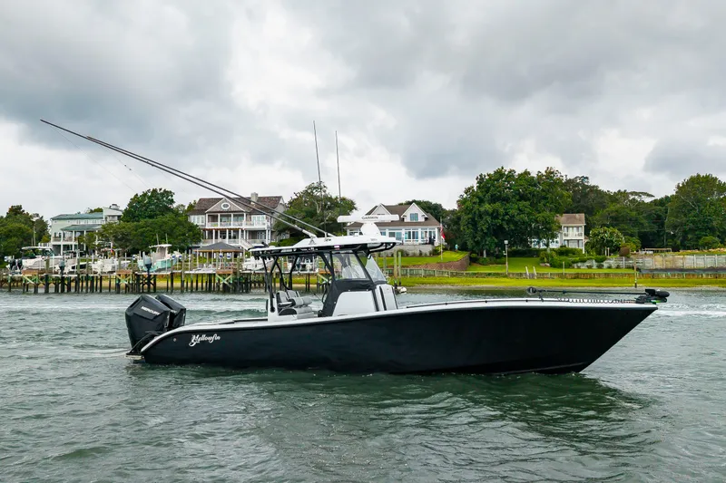 Slide: The Image of 2025 Yellowfin 32 Offshore on the water with coastal homes in the background. - 39