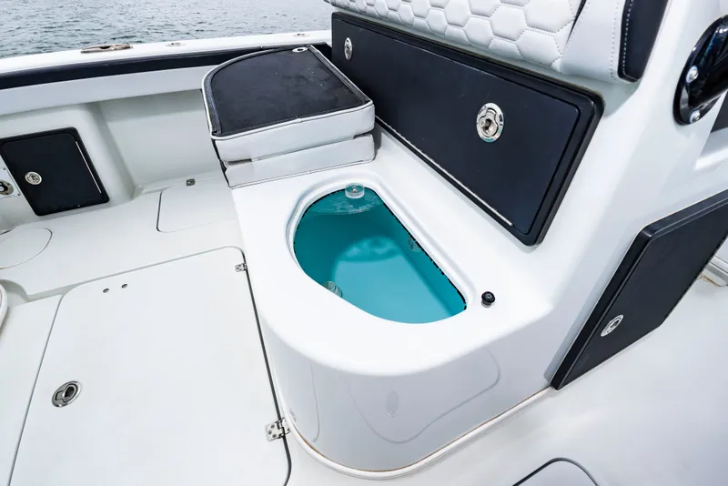Slide: The Image of The image shows the cockpit of a 2025 Yellowfin 32 Offshore with an open blue livewell. - 20