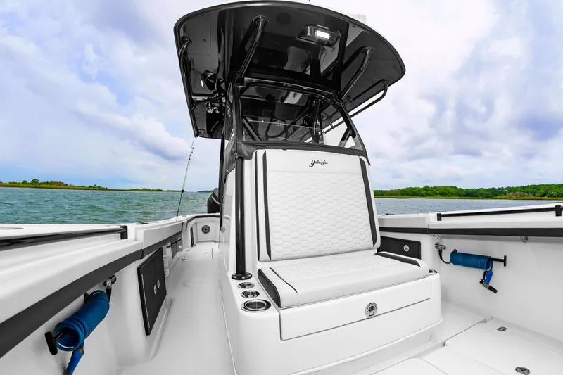 Slide: The Image of The image shows a modern boat with a sleek white seating area and a black canopy. - 31
