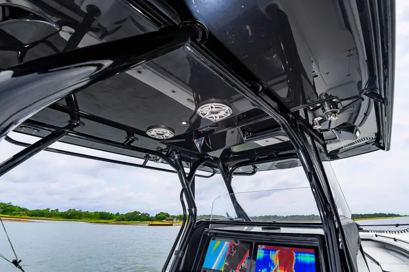 Slide: The Image of The image shows the cockpit of a Yellowfin 32 Offshore boat with modern electronics and speakers. - 25
