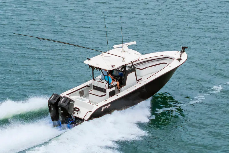 Slide: The Image of A modern white boat with two outboard engines speeds across the water. - 5