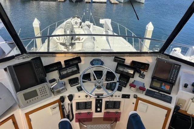 Slide: The Image of Cockpit view of a 1994 Mikelson 64 yacht with navigational instruments and steering wheel. - 59